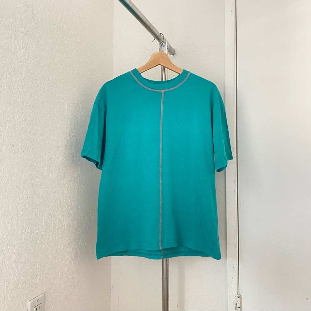 teal t shirt with orange contrast stitching